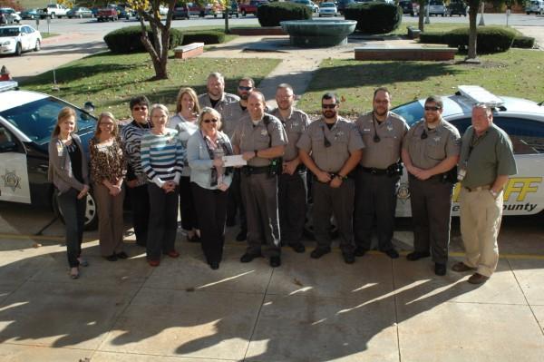 Sheriff's office staff and deputies standing in front of vehicles
