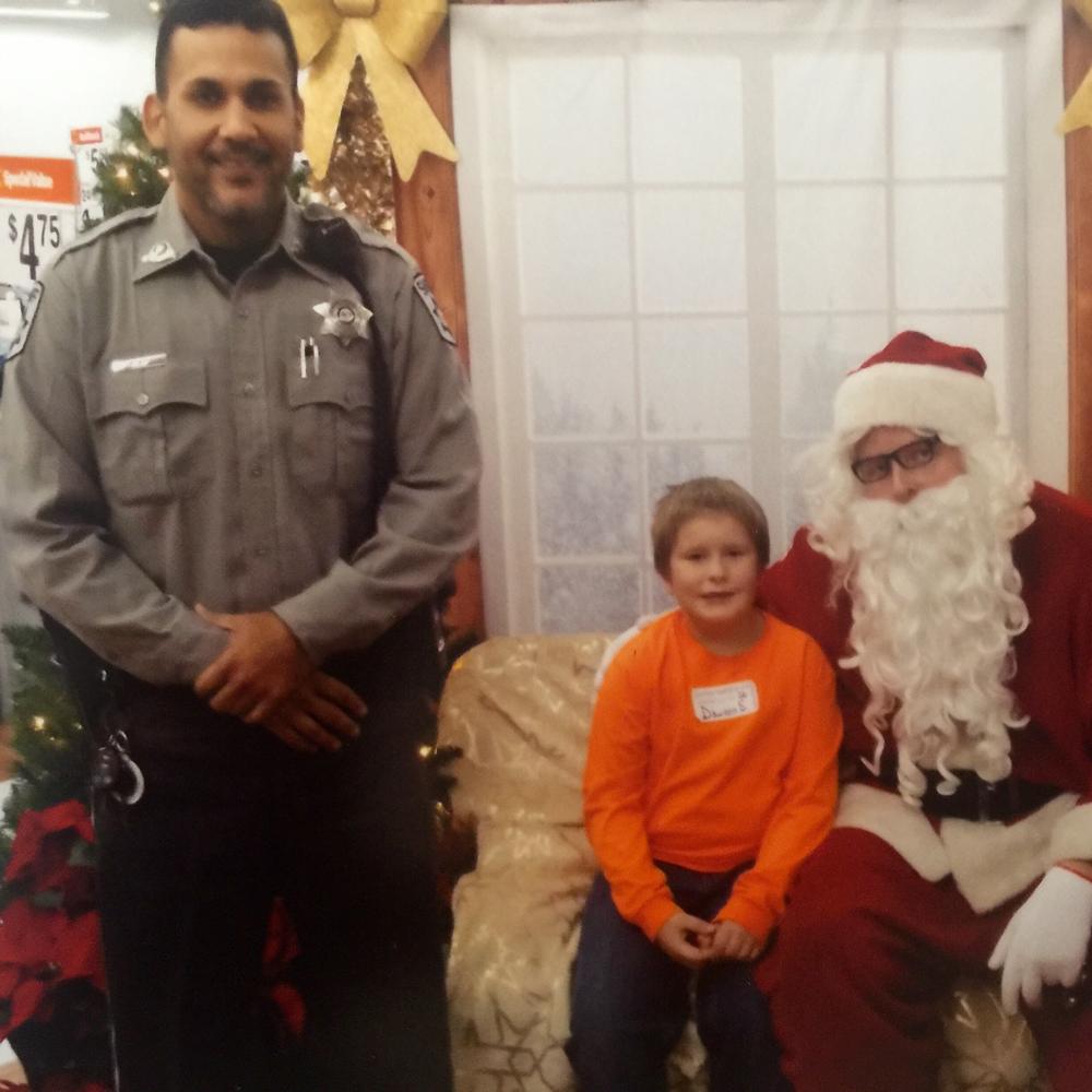 cop, child, and Santa.