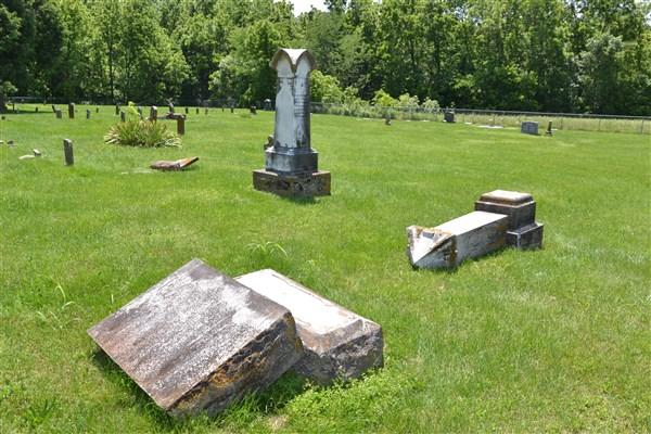 Tombstones broken and laying on ground