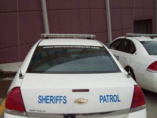LCSO Website sticker added to the back of the sheriffs patrol car window.