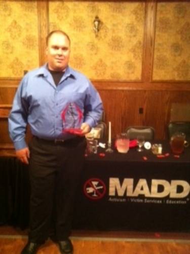 Deputy Devost in front of M.A.D.D. booth